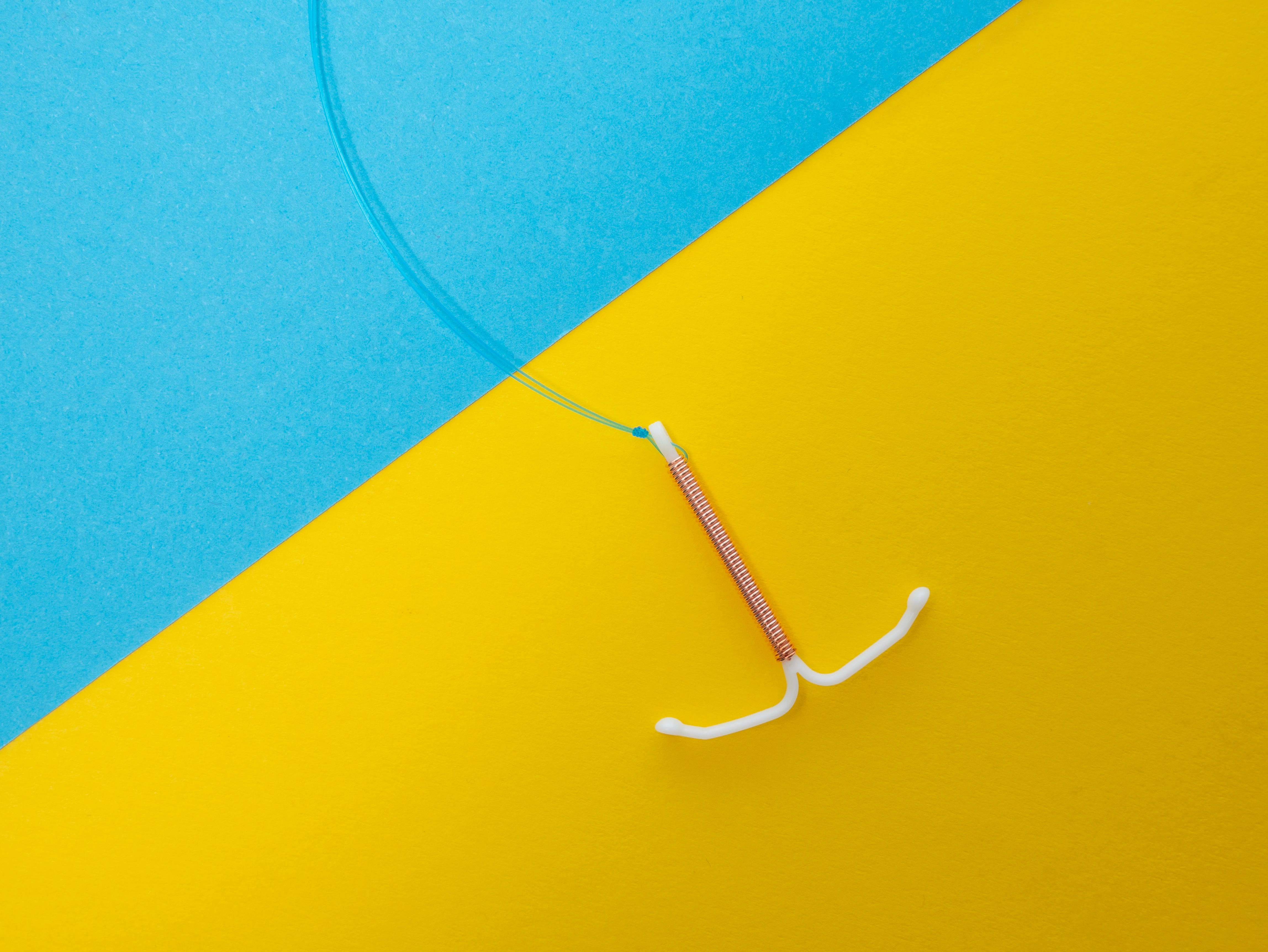 IUD on blue yellow background